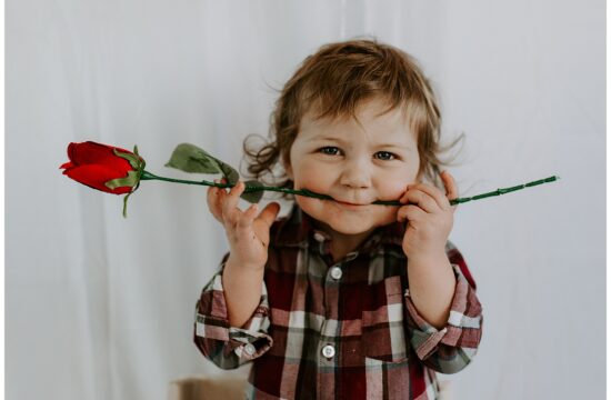 toddler boy with rose in his mouth